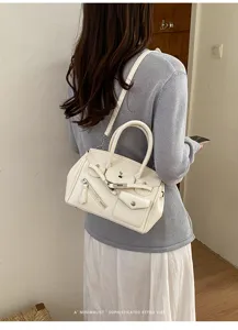 White Korean niche design handbag detail, stylish shoulder bag with front pocket design.