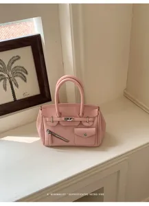 Chic pink retro handbag with metal lock and top handle for women elegant daily commute
