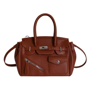 Brown leather handbag for women, stylish tote bag with top handle and classic lock design.