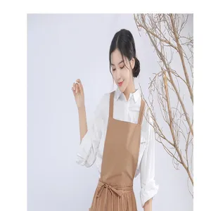 Detailed view of japanese style brown cotton linen apron featuring utility pocket design.