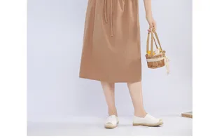 Detail view of Japanese style cotton linen apron, featuring drawstring waist and practical pocket.