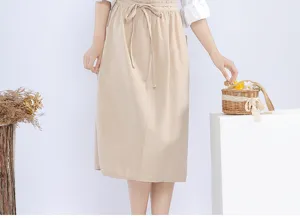 Japanese cotton linen half apron detail view, beige waist tie design for bakery floral art.