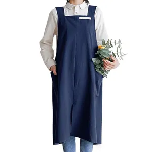 Detailed view of the dark blue Japanese style cotton apron with deep pockets and cross back.