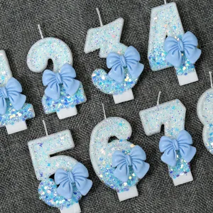 Blue glitter number candles with cute bows for birthday party cake decoration, magical design.