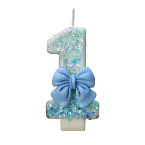 Blue glitter number 1 birthday candle with bow for party cake decoration main view.