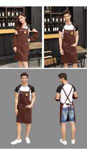 Poly-cotton work apron with sleeves and smiley patch, ideal for kitchen, cafe and restaurant use.