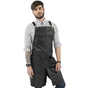 Durable black work apron with cross back straps, multiple utility pockets for workshop use.