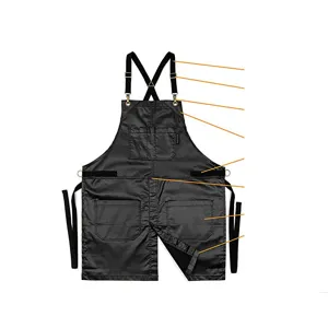 Cross back work apron with multiple tool pockets, adjustable straps and durable black fabric.