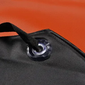 Waterproof black and orange PVC work apron main view showing durable reinforced strap eyelet.