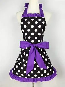 Retro polka dot apron detail with purple bow and ruffles, ideal for kitchen or work.