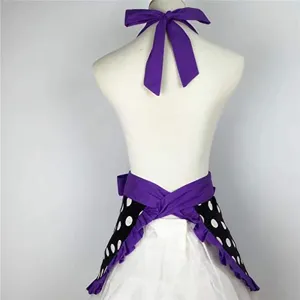 Retro cotton halter apron featuring polka dots, ruffled hem and large purple bow back.