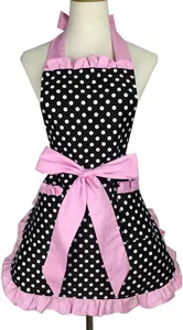 Stylish retro black white polka dot apron with pink ruffles and large bow for cooking.