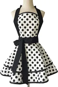 Vintage black and white polka dot apron with ruffled skirt, halter neck and bow accent detail.