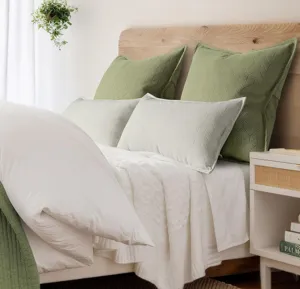 Detailed view of soft chenille decorative pillow sham in bedroom setting for cozy home decor.