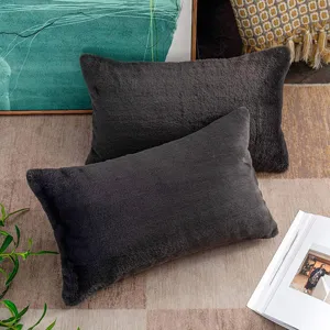 Dark gray faux fur rectangular throw pillow detail, soft plush fabric for sofa and bed decor.