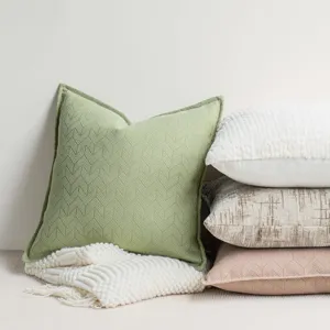 Chenille throw pillow detail, textured green cushion close-up, cozy home decor fabric.