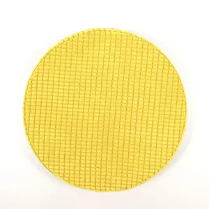 Close up detail of round yellow corduroy fabric tatami cushion, comfortable home floor mat.