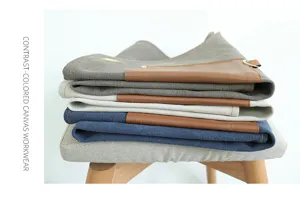 Retro multi-pocket canvas work apron detail showcasing durable fabric and stylish leather pockets.