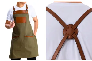 Close-up detail of the durable canvas apron with stylish brown leather straps and pockets.