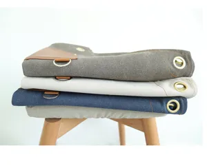 Stacked retro canvas tool aprons detail showing multi colors, brass eyelets and d-rings.
