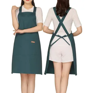 Dark green cross back apron with adjustable straps and large pocket. Ideal for cafe cooking.