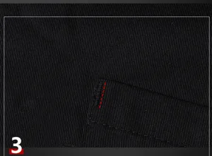 Black work apron detail close-up showing durable fabric and neat stitching craftsmanship.