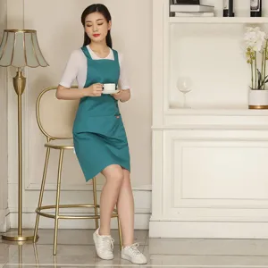 Adjustable cross-back teal work apron with pocket for kitchen cafe barista uniform use.
