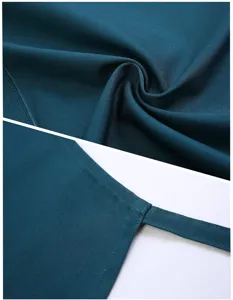 Dark green polyester-cotton apron fabric texture and neat edge stitching detail shot