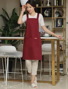 Solid wine red kitchen apron with cross back straps and front pocket for cooking or baking.