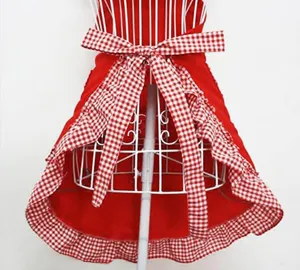 Detail shot of the red and white gingham apron featuring a cute double layer ruffle hem and bow.
