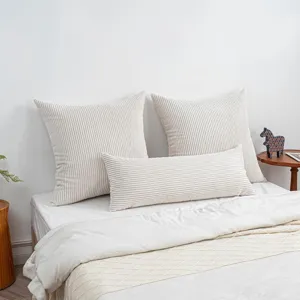 Detail shot of corduroy long body pillow and square pillow set on bed, soft texture.