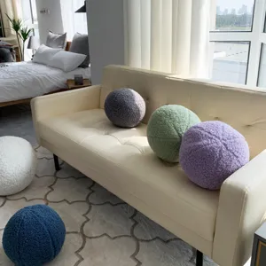 Modern spherical teddy fleece throw pillow detail in cozy home living room setting view.
