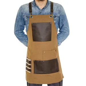 Durable canvas work apron featuring leather pockets and cross-back straps for comfort.