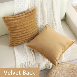 Faux rabbit fur striped pillow and velvet back cushion detailed view in cozy home living room.