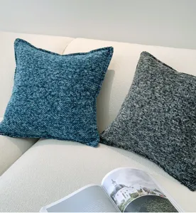 Gedetailleerde opname van getextureerd chenille sierkussen met zachte stof voor interieur.