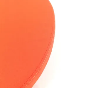 Orange cotton canvas cushion detail, round seat pad close up showing fine stitching.