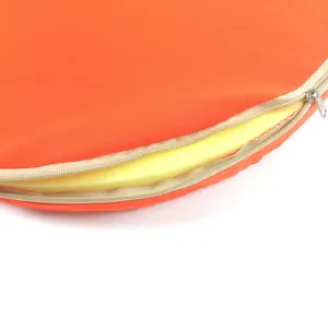 Orange cotton canvas seat cushion detail view, zipper open showing yellow sponge core.
