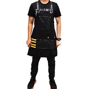 Black canvas work apron with leather straps, multiple tool pockets for woodworking and BBQ.