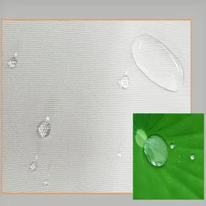 Detailed shot of waterproof fabric for kitchen apron featuring water repellent beaded droplets.