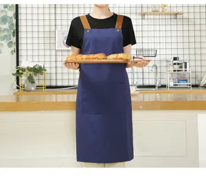 Nordic canvas kitchen apron with cross straps and pocket, ideal for restaurant and cafe work.