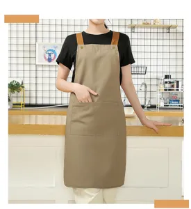 Detailed view of minimalist Nordic canvas apron with pockets, perfect for kitchen use.