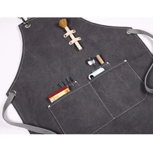 Tablier de cuisine en toile gris foncé avec poches multiples et lanières pour barista pro.
