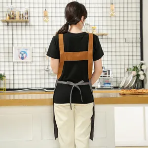 Nordic canvas kitchen apron with cross back straps and adjustable waist tie for cooking.