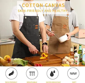 Cotton canvas work apron detail showing multi pockets and adjustable leather straps in kitchen.