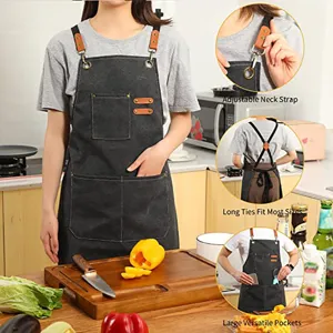 Adjustable canvas kitchen apron detail showing neck strap, long ties and deep pockets.