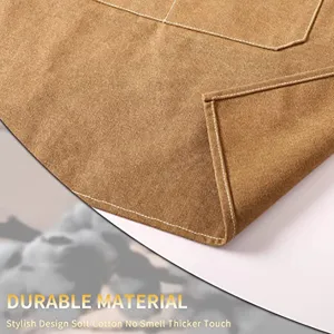 Thickened canvas work apron detail showcasing durable cotton fabric, neat stitching and pockets.