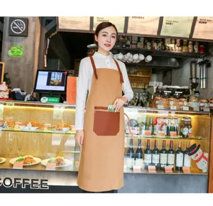 Tablier en toile marron sans manches de style coréen avec lanières et grande poche pour café.