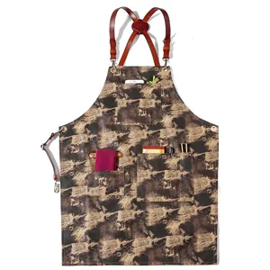Vintage patterned canvas work apron with leather cross straps and convenient multi-pockets.