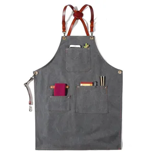 Vintage canvas work apron with leather straps and multiple pockets for baristas and chefs.
