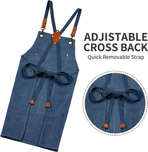 Adjustable cross back canvas apron detail showing quick removable straps and durable leather buckles.